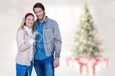 Composite image of smiling couple showing credit card