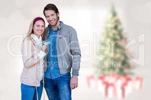 Composite image of smiling couple showing credit card