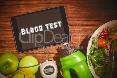 Blood test against tablet on healthy persons table