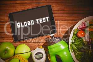 Blood test against tablet on healthy persons table