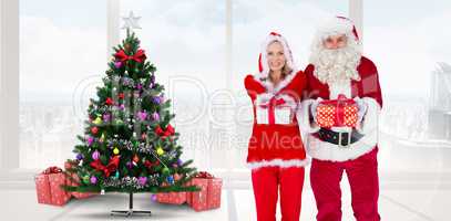 Composite image of santa and mrs claus smiling at camera offerin