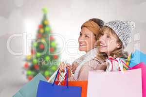 Composite image of beautiful women holding shopping bags looking