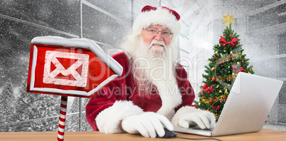 Composite image of santa surfs on the internet