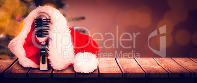 Composite image of vintage mic with santa hat
