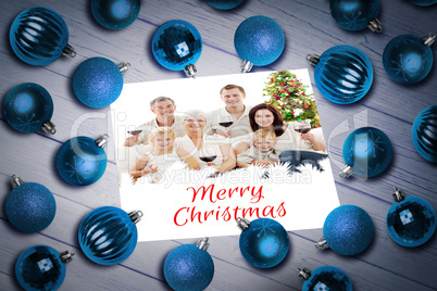 Composite image of christmas baubles on table