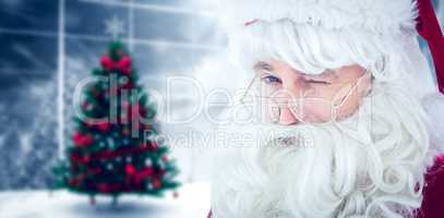 Composite image of portrait of santa claus winking