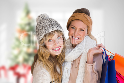 Composite image of beautiful women holding shopping bags looking