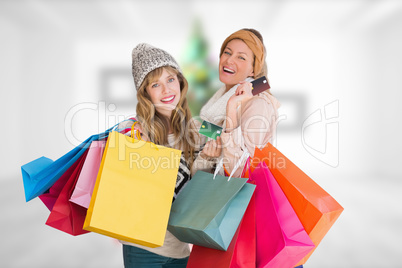 Composite image of beautiful women holding shopping bags looking