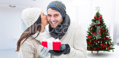 Composite image of winter couple holding gift