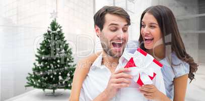 Composite image of woman surprising boyfriend with gift
