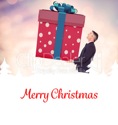 Composite image of stylish man with giant gift