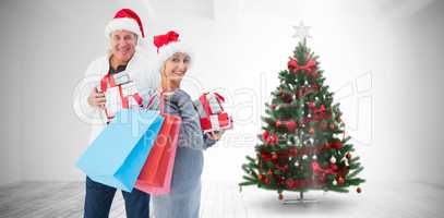 Composite image of couple with shopping bags and gifts