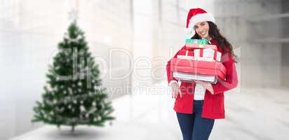 Composite image of festive brunette in santa hat and red coat ho