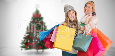 Composite image of beautiful women holding shopping bags looking