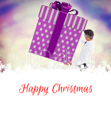 Composite image of stylish man with giant gift