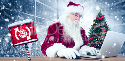 Composite image of santa surfs on the internet