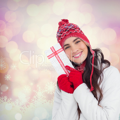 Composite image of festive brunette in winter clothes pointing g