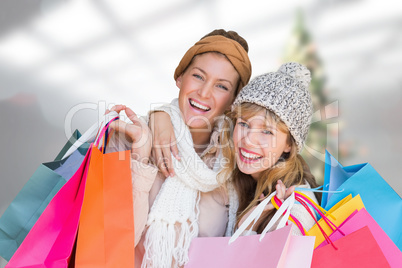 Composite image of smiling women looking at camera with shopping