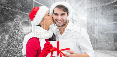 Composite image of festive young couple holding gift