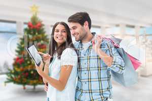 Composite image of happy couple with shopping bags