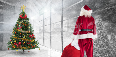 Composite image of santa carrying sack of gifts