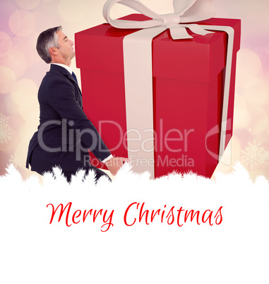 Composite image of stylish man with giant gift