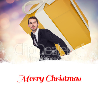 Composite image of stylish man with giant gift