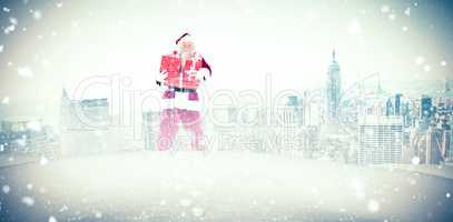 Composite image of santa carrying gifts