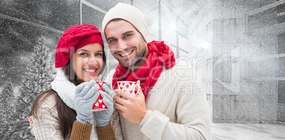 Composite image of winter couple holding mugs