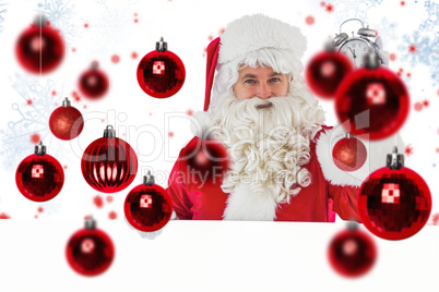 Composite image of santa claus holding alarm clock and sign