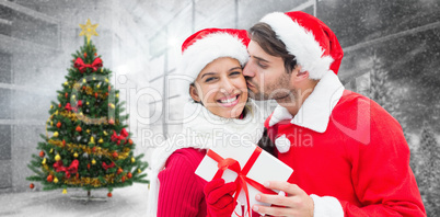 Composite image of festive young couple holding gift