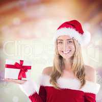 Composite image of pretty santa girl holding gift