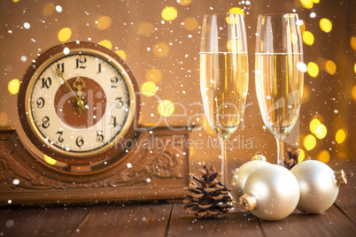 Christmas card. Glasses of champagne on New Year's Eve on the stand an ancient clock with snow