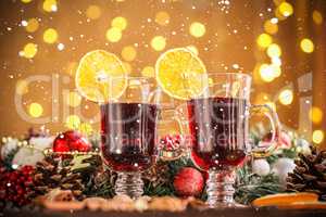 Christmas hot mulled wine with spices on a wooden table with snow. The idea for creating greeting cards