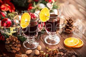 Christmas hot mulled wine with spices on a wooden table. The idea for creating greeting cards