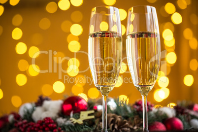 Two champagne glass on christmas bokeh background