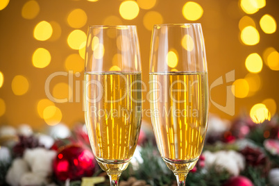 Two champagne glass on christmas bokeh background