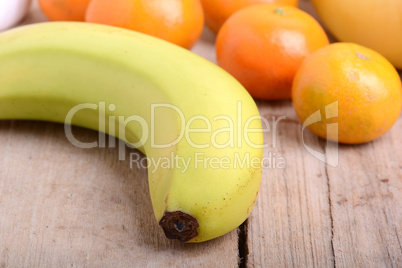 Fresh colorful fruits composition mandarin, bananas and orange