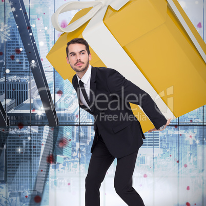 Composite image of stylish man with giant gift