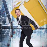 Composite image of stylish man with giant gift