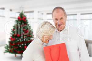 Composite image of couple with shopping bag