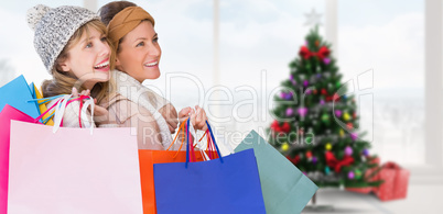 Composite image of beautiful women holding shopping bags looking