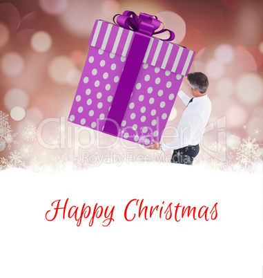 Composite image of stylish man with giant gift