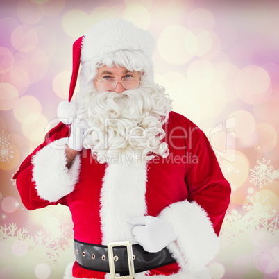 Composite image of smiling santa claus with his sack