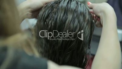 Close-up hairdresser combing and blow dry for client hair in hairdressing salon