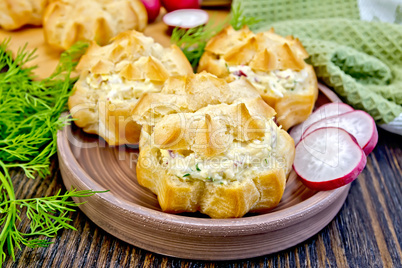 Appetizer of radish and cheese in profiteroles on clay plate