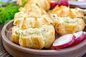 Appetizer of radish and cheese in profiteroles on plate with dil