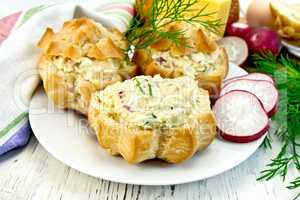 Appetizer of radish and cheese in profiteroles on plate