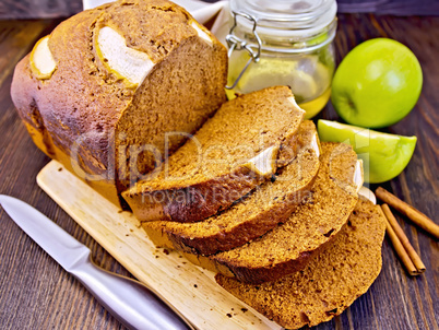 Bread apple with honey on dark board