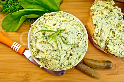 Butter with spinach and herbs in bowl on board top